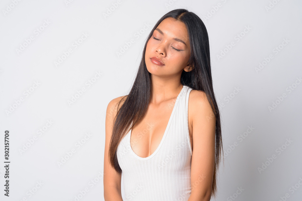 Portrait of young beautiful Asian woman relaxing with eyes closed Portrait of young beautiful Asian woman relaxing with eyes closed