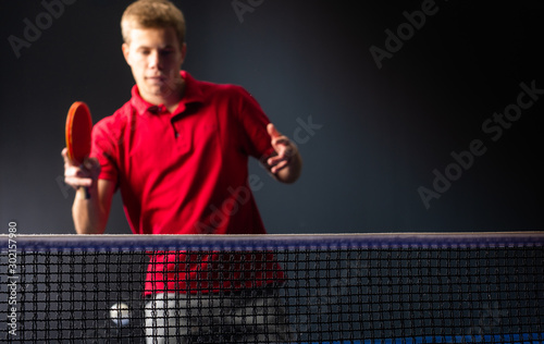 Young man playing table tennis.