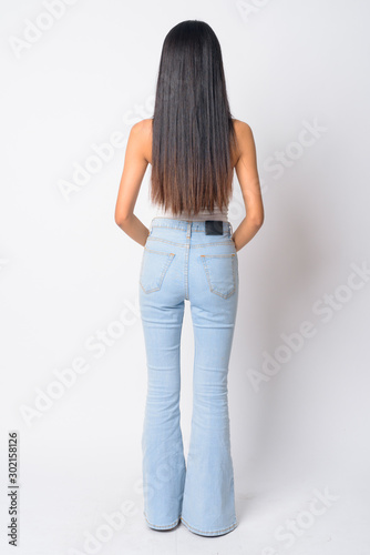 Full body shot rear view of young Asian woman