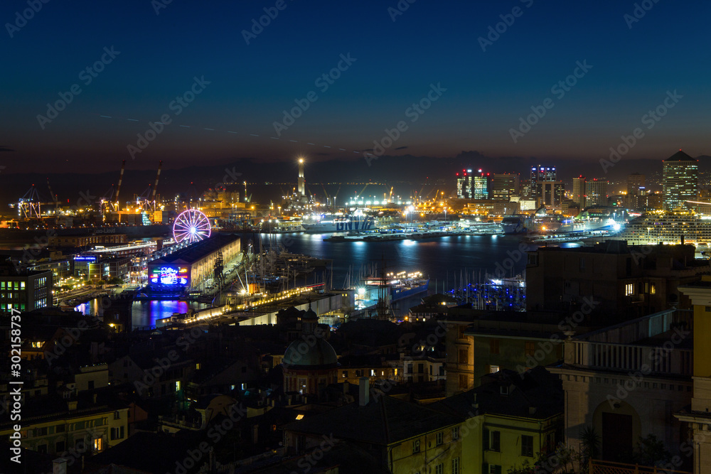 GENOA, ITALY, NOVEMBER  5, 2019 - Aerial view of Genoa, Italy at night, the harbor with the hiistoric centre, Italy, Europe