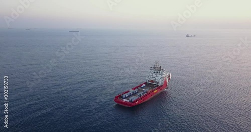 Aerial top view of an Offshore Supply Ship in the calm ocean water.