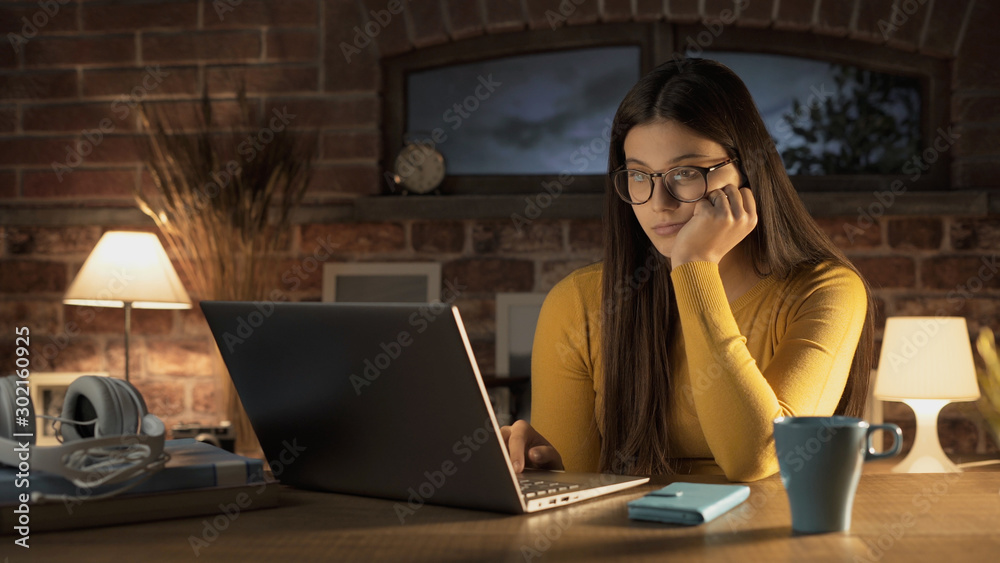 Young woman connecting with her laptop at home Young woman connecting with her laptop at home