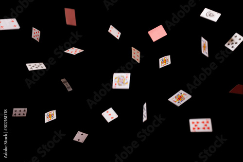 Game cards strew on a black background. Isolate. banner. Many playing cards of different suits on a black background. Close-up, сopy space.  
