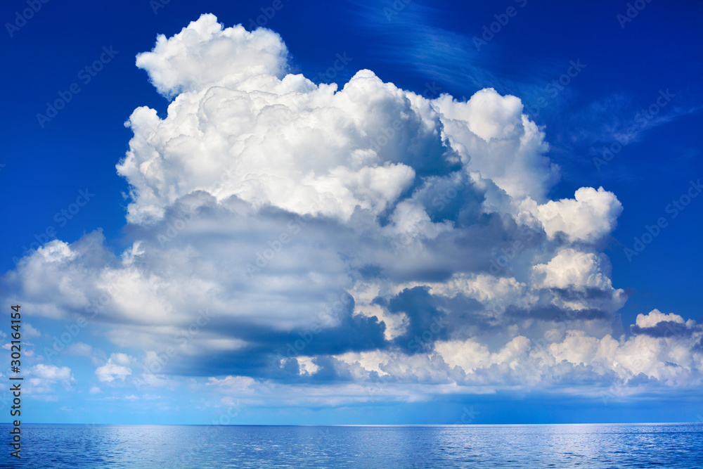White cumulus clouds over sea close up blue sky background landscape, big fluffy cloud above ocean water panorama, scenic tropical sunny summer day cloudy weather seascape view, cloudscape, copy space