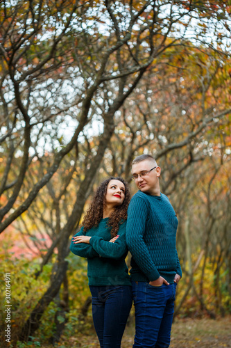 Couple in sweaters in the autumn park