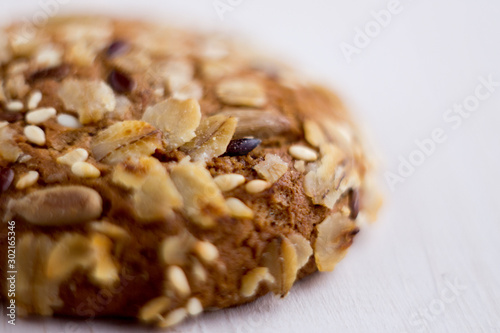 close up homemade backed cereal oat cookie on white background. macro healthy food photography