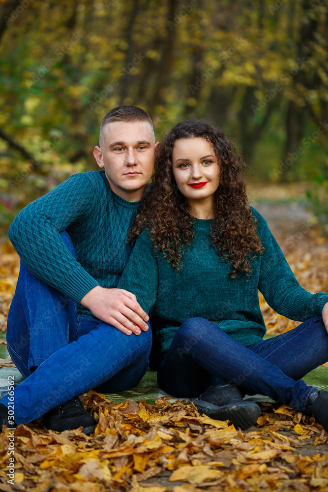 Couple in sweaters in the autumn park
