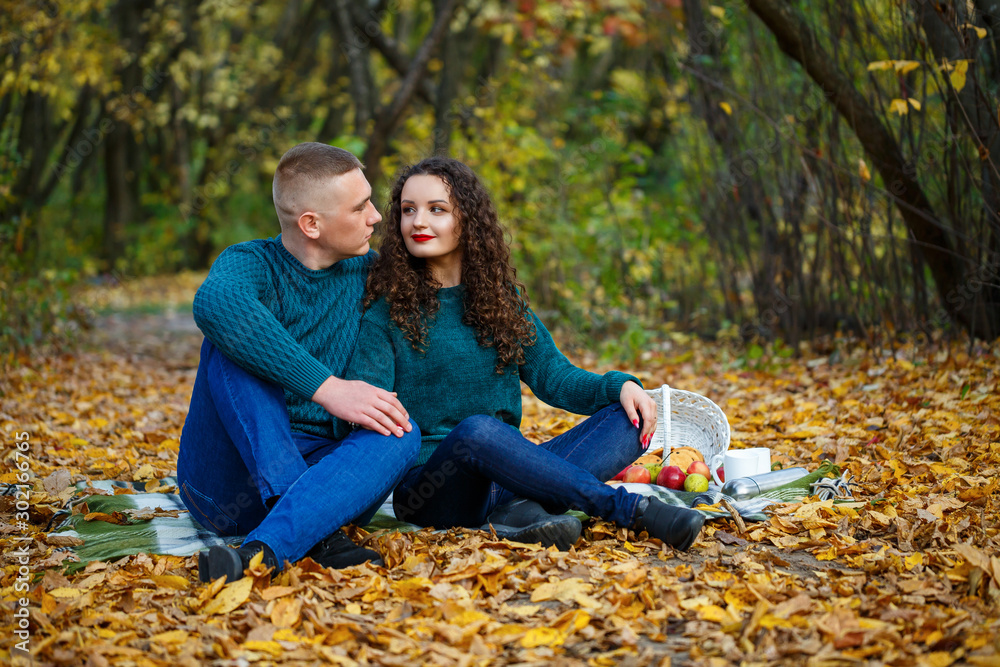 Couple in sweaters in the autumn park Couple in sweaters in the autumn park