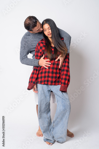 Full body shot of multi ethnic couple together and in love