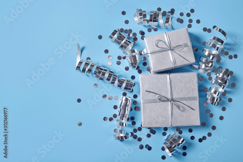 Festive bckground with presents, confetti and ribbons.