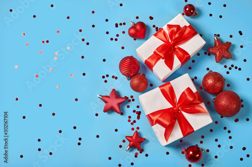 Christmas background with gift boxes and red ribbons.