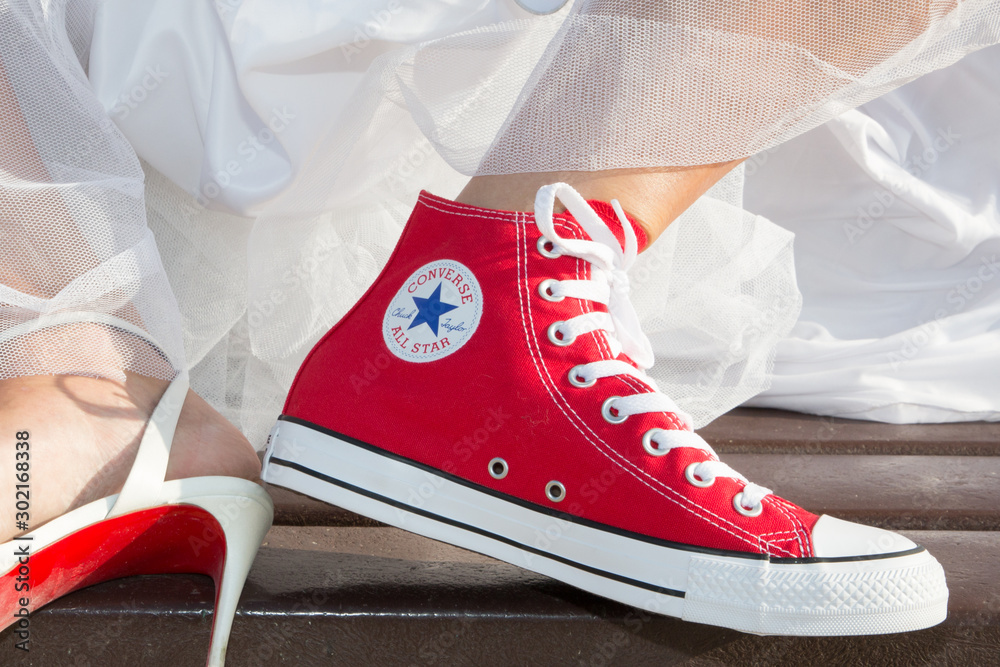 Bride feet Wedding Dress and red Sneakers converse all star chuck taylor  Stock Photo | Adobe Stock