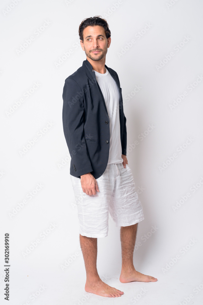 Full body shot of handsome Hispanic businessman thinking Full body shot of handsome Hispanic businessman thinking