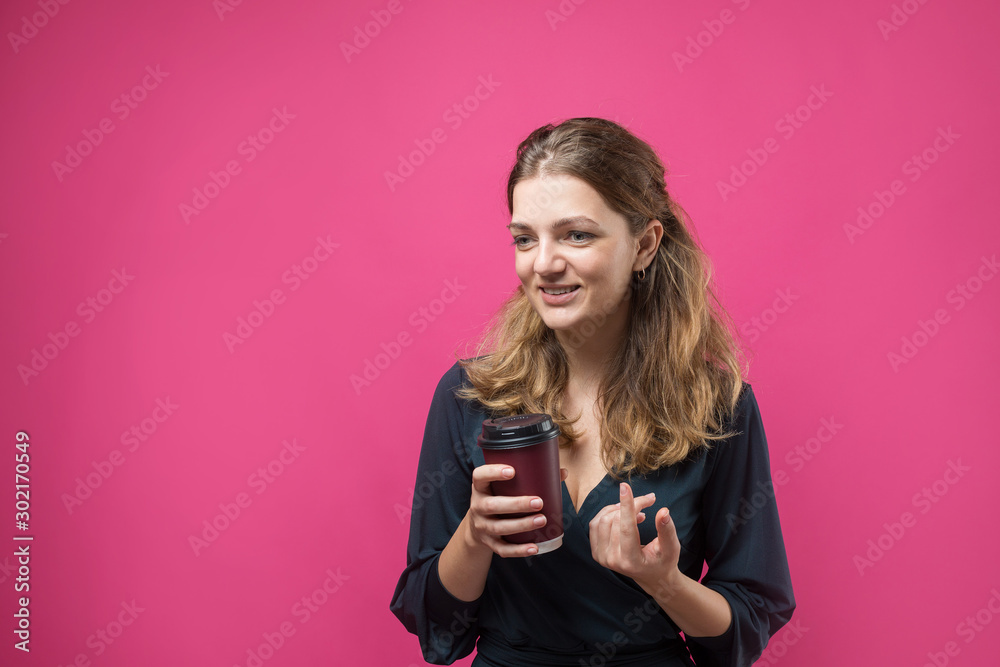 Glamor woman with a drink of coffee on a pink background Glamor woman with a drink of coffee on a pink background