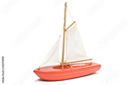 Toy red yacht isolated on a white background. Clipping path included.