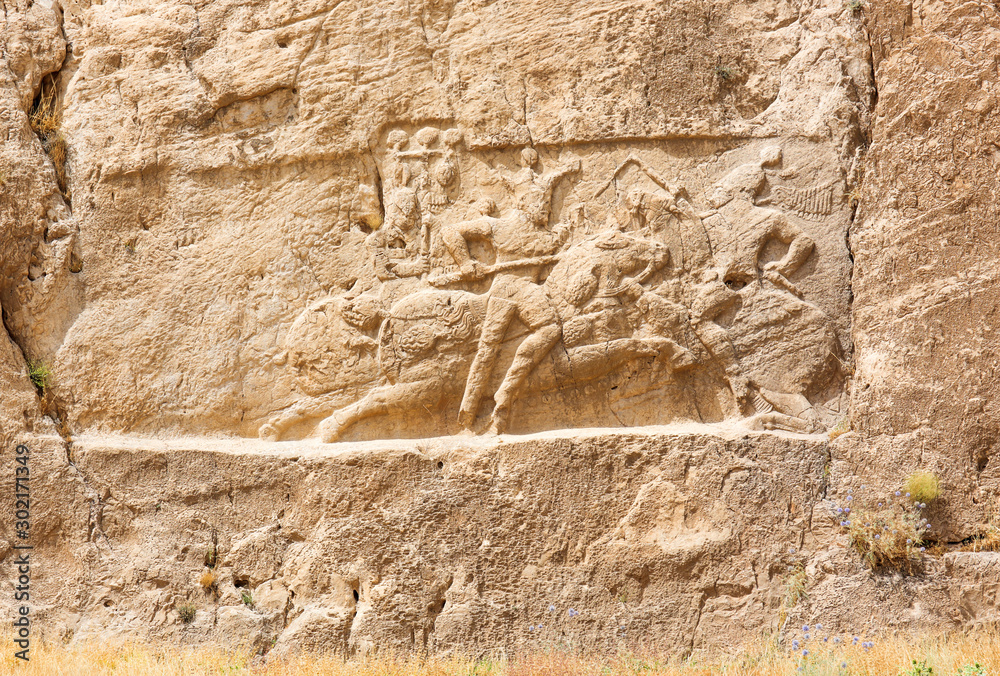Image of assyrian warriors with spears in their hands. Ancient reliefs on the ruined walls of the Persepolis. Persepolis. Iran. Image of assyrian warriors with spears in their hands. Ancient reliefs on the ruined walls of the Persepolis. Persepolis. Iran.