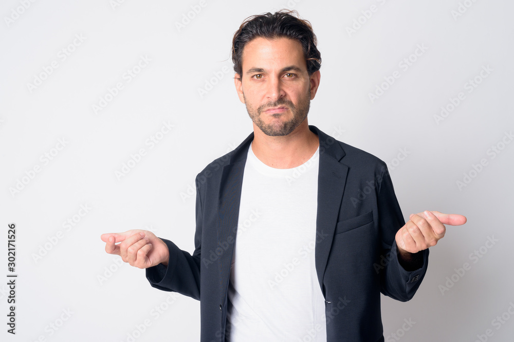 Portrait of stressed Hispanic businessman looking angry with arms raised Portrait of stressed Hispanic businessman looking angry with arms raised