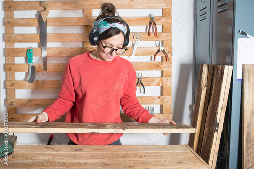 woman sanding a restored wood