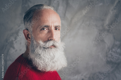 Closeup photo of serious aged business guy looking minded on camera wear red knitted pullover jumper cool hipster outfit isolated grey color concrete wall background