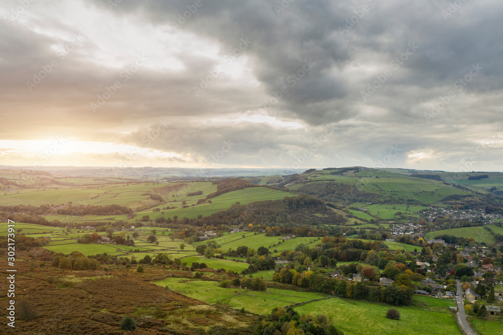 Stunning Autumn Fall landscape aerial drone image of countryside view from Curbar Edge in Peak District England at sunset