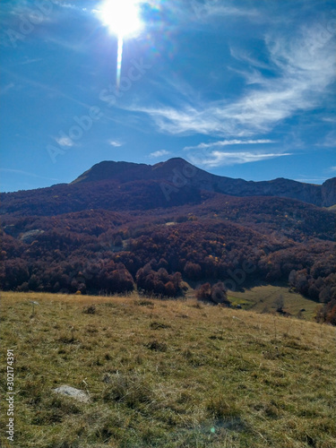 Beautiful landscape of mountain peak in the natural untouched environment with colorful forest and grass valley