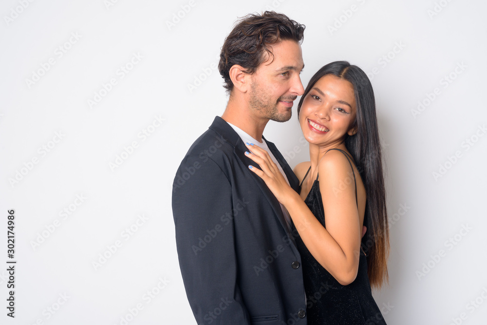 Portrait of happy multi ethnic business couple embracing together Portrait of happy multi ethnic business couple embracing together