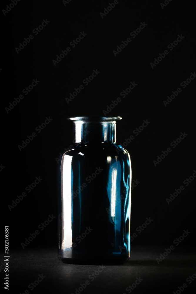  glass bottle against a dark background
