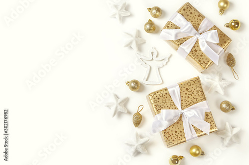 Christmas decoration and golden gift boxes on white background.