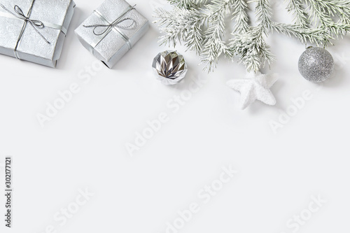 Christmas ball and presents with ribbon on white background.