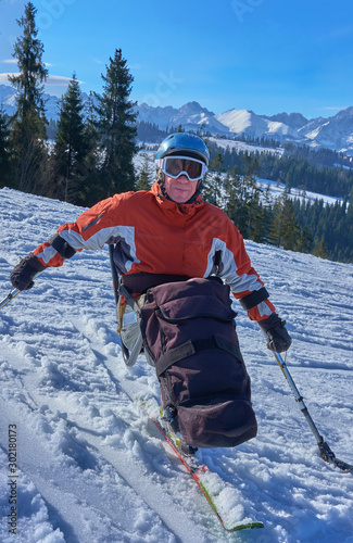 handicapped athlete goes mono ski,  downhill skiing, extreme sport and winter snow sports for wheelchair  photo