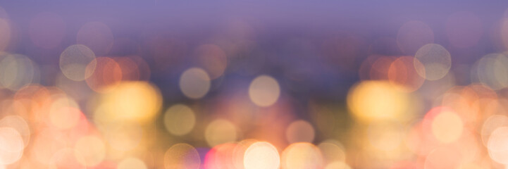 Panoramic web banner of blurred bokeh festive holidays lights at night, christmas and new year celebration background