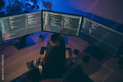 Back rear top above high angle view photo of coder debugging protection software of her corporation removing failures and errors