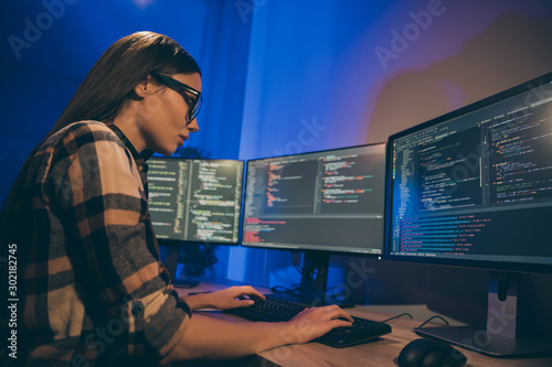 Photography Photo of focused concentrated serious programmer looking through code of artific