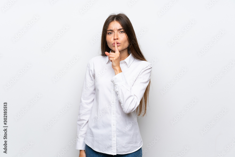 Young woman over isolated white background doing silence gesture Young woman over isolated white background doing silence gesture