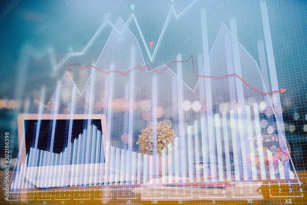 Forex graph hologram on table with computer background. Double exposure. Concept of financial markets. Forex graph hologram on table with computer background. Double exposure. Concept of financial markets.