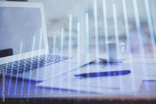 Forex graph hologram on table with computer background. Double exposure. Concept of financial markets.