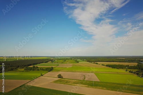 Fields for agriculture and wind power in summer