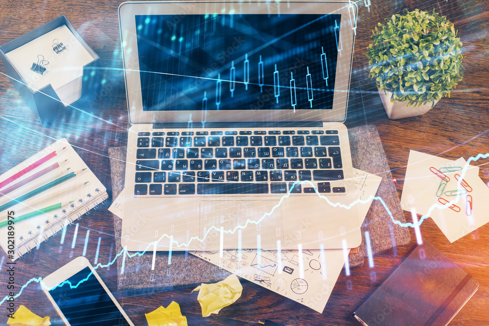 Multi exposure of graph and financial info and work space with computer background. Concept of international online trading. Multi exposure of graph and financial info and work space with computer background. Concept of international online trading.
