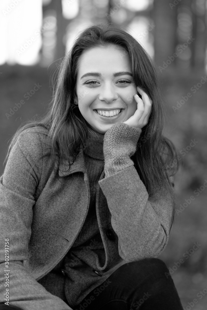 beauty art portrait of smilling young attractive woman in park, fashion model with clean skin, natural cosmetics and makeup, black and white photo, emotions