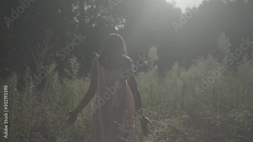 young woman walking through the valley. S-log, ungraded photo