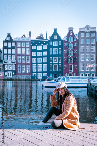 Photography Young woman in Amsterdam, girl at waterforn in the city of Amsterdam Netherlands