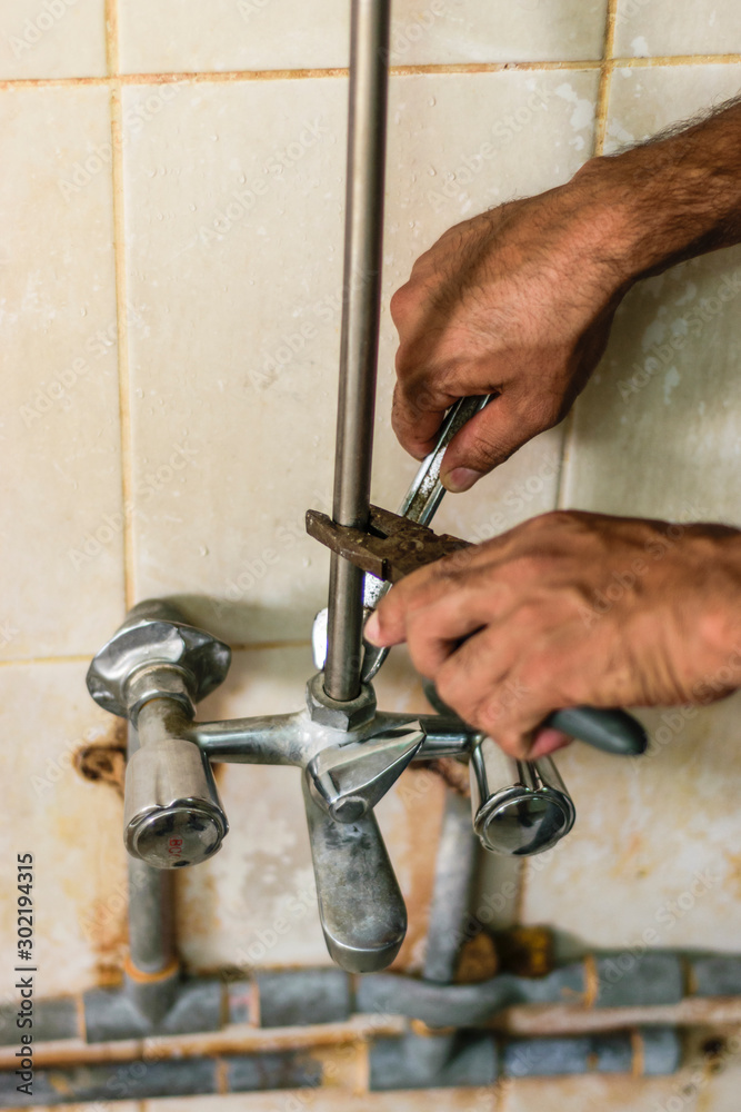 technician fixing the home water pipe technician fixing the home water pipe