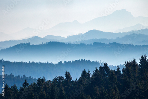 View of mountain ridges separated by aerial perspective..Mountainous countryside of the Moravian-Silesian Beskids range in the Czech Republic, Europe.