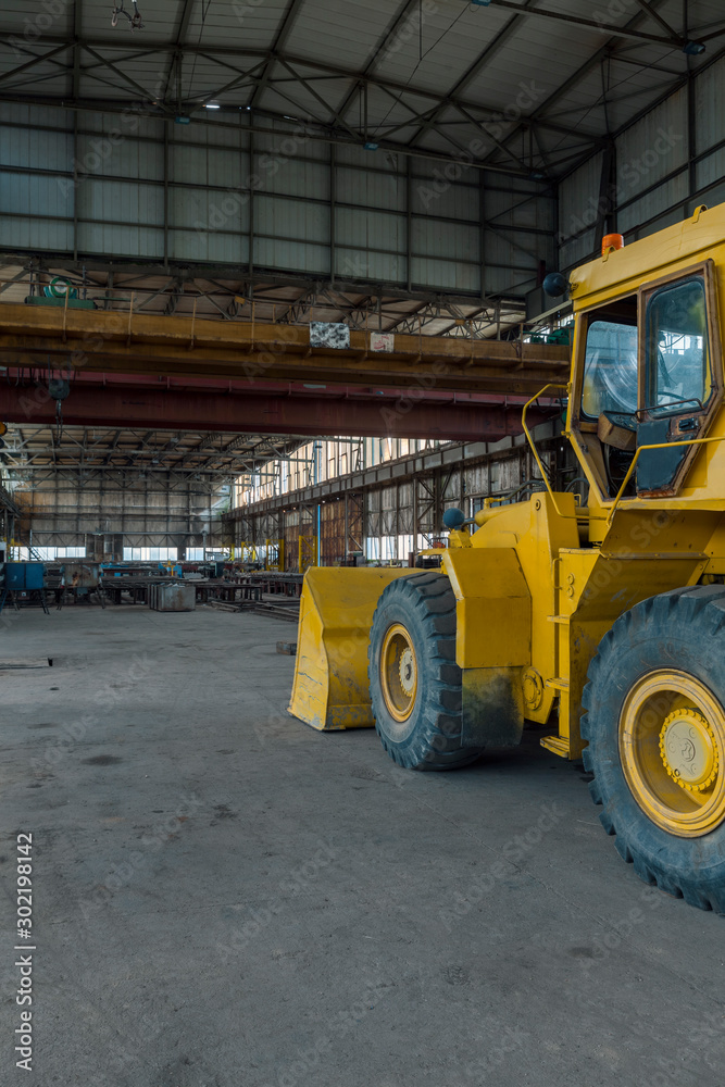 bulldozer in a large industrial building