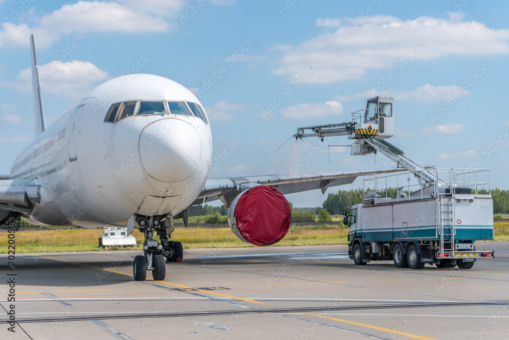 Fototapeta premium De-icing aircraft in airport
