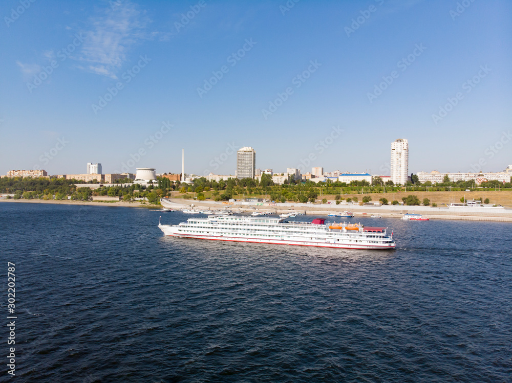 A cruise ship with tourists passes by the central embankment of Volgograd, goes down the Volga to Astrakhan. Volgograd. Russia A cruise ship with tourists passes by the central embankment of Volgograd, goes down the Volga to Astrakhan. Volgograd. Russia