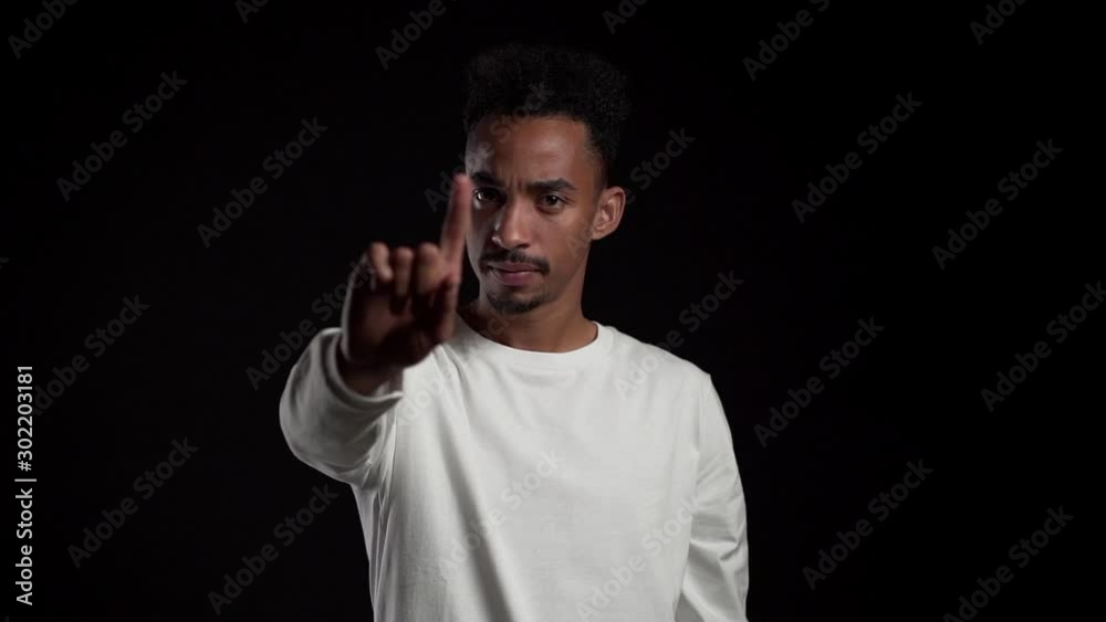 African american man disapproving with no hand sign make negation finger gesture. Denying, Rejecting, Disagree, Portrait of handsome guy. Slow motion. African american man disapproving with no hand sign make negation finger gesture. Denying, Rejecting, Disagree, Portrait of handsome guy. Slow motion.