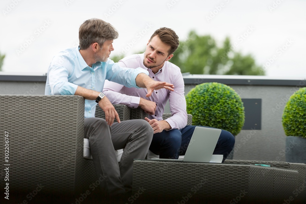 Fototapeta premium Businessmen discussing plans in office rooftop