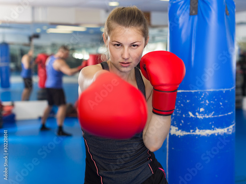 Portrait of  woman who is training in box gym. © JackF