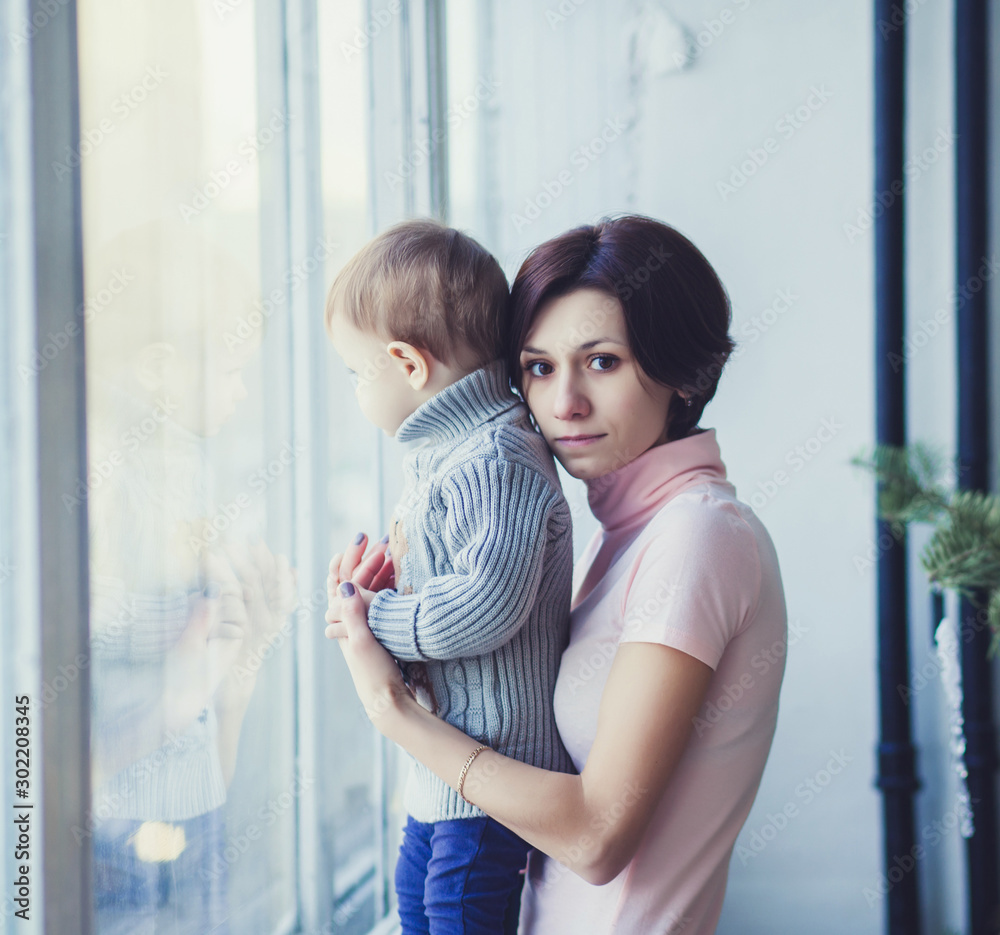 mother and daughter near the window hugging mother and daughter near the window hugging